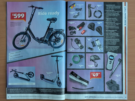 A photo of an Aldi brochure, showing a fold-up ebike, an escooter, and several bike accessories