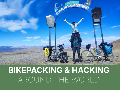 a photo of javi and rebecca with their bikes under a sign in a desertic environment. below the text "bikepacking & hacking around the world"