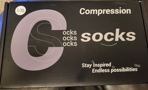 A box of compression socks, with the log written in such a way that it appears to say "Cocks Cocks Cocks"